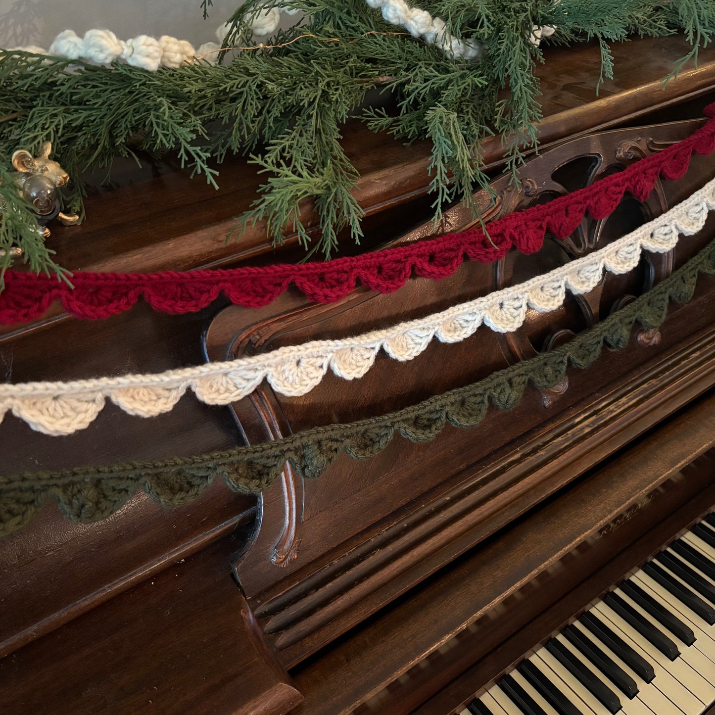 Decorative garland with red and white ribbons on a piano