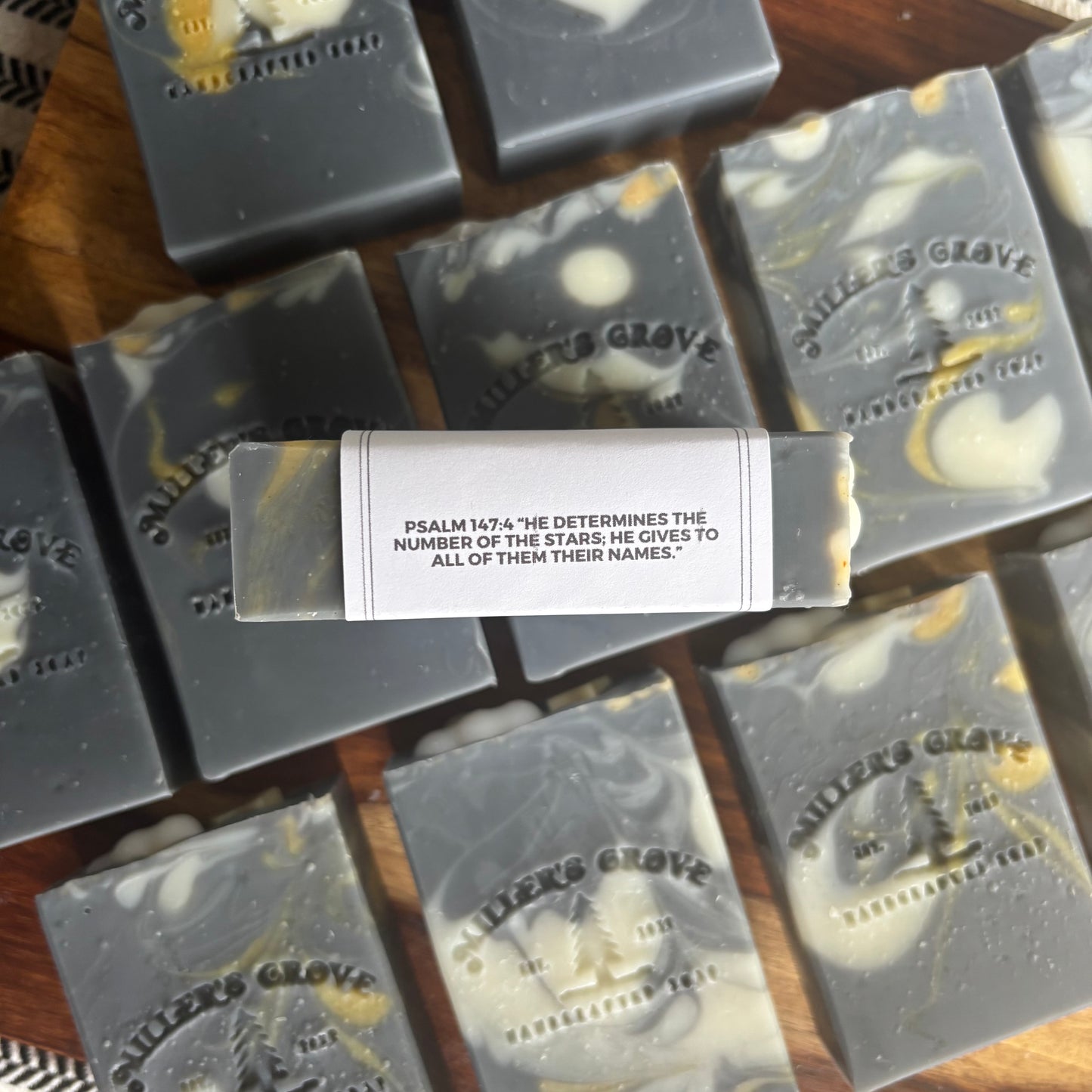 Bars of soap with 'Miller's Grove' branding on a wooden surface.
