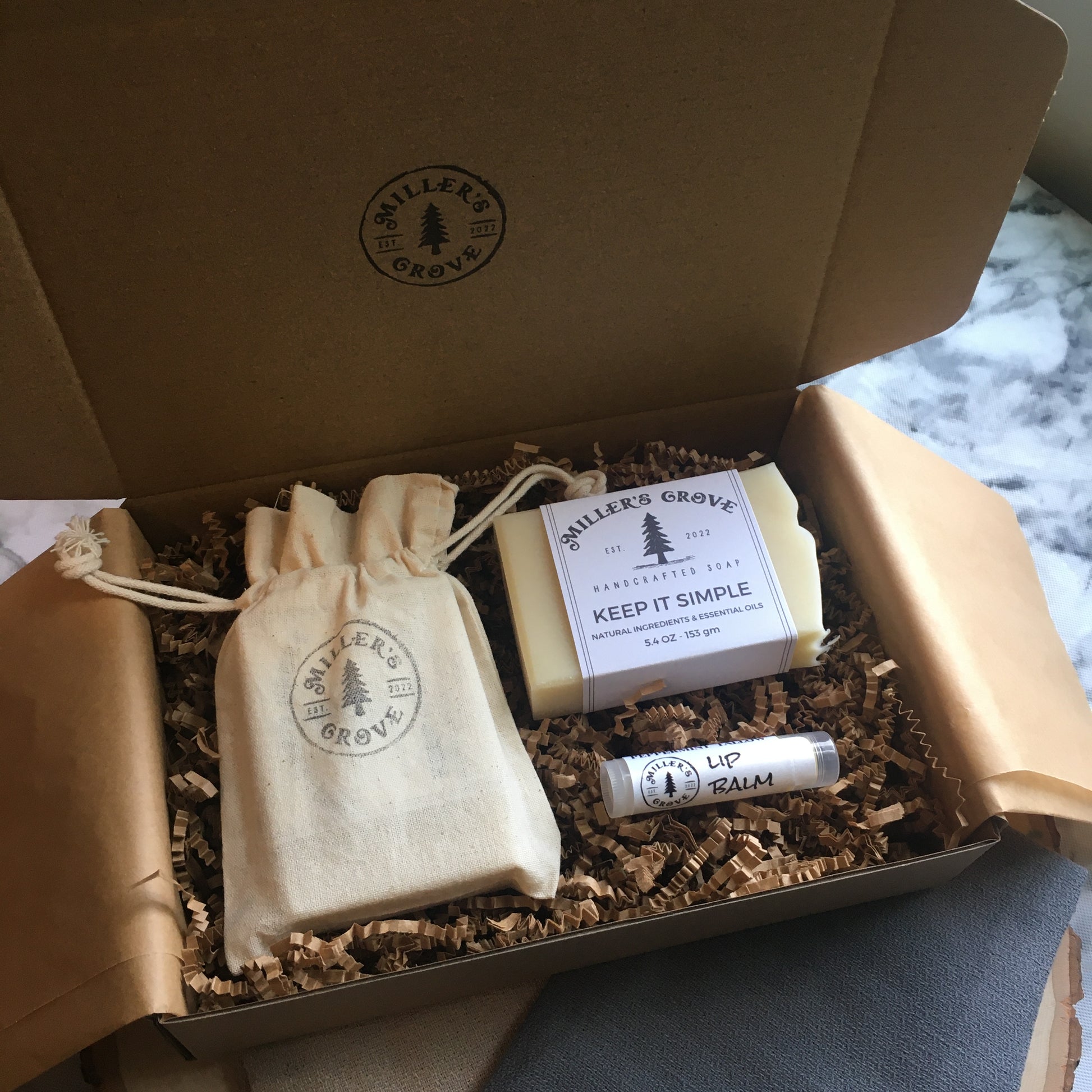 example of items in a brown gift box with brown crinkle paper