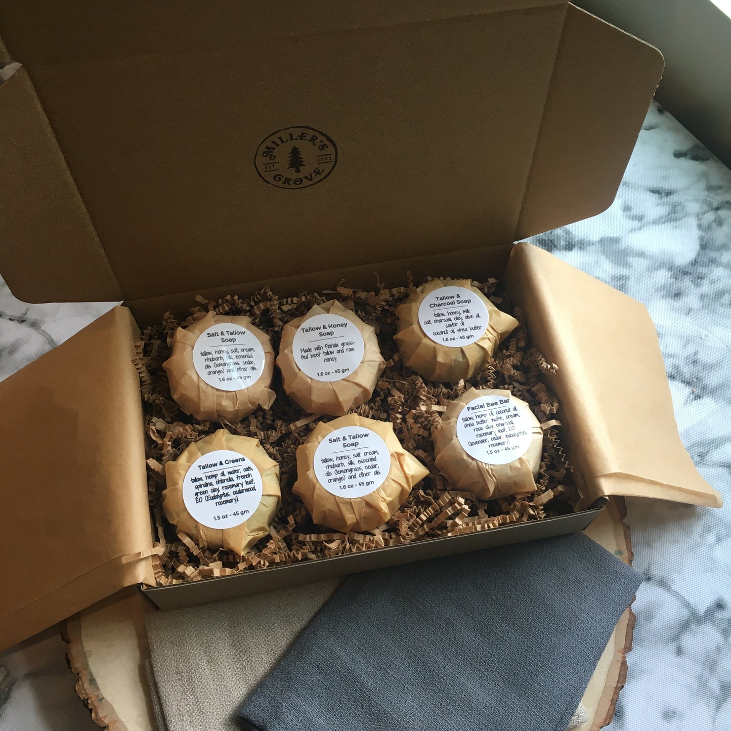 example of items in a brown cardboard gift box and brown crinkle paper