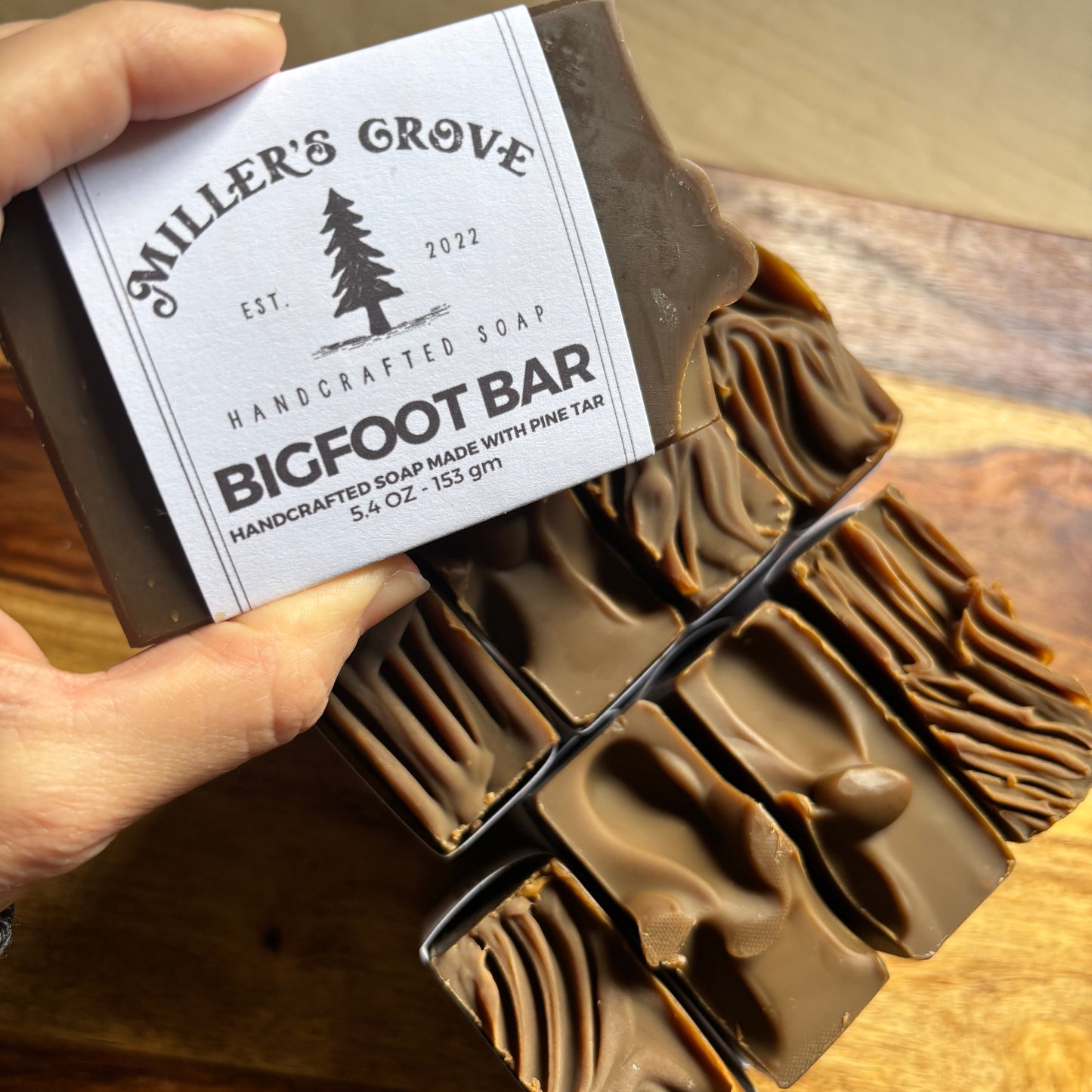 Handmade soap bar with a visible label on a wooden surface