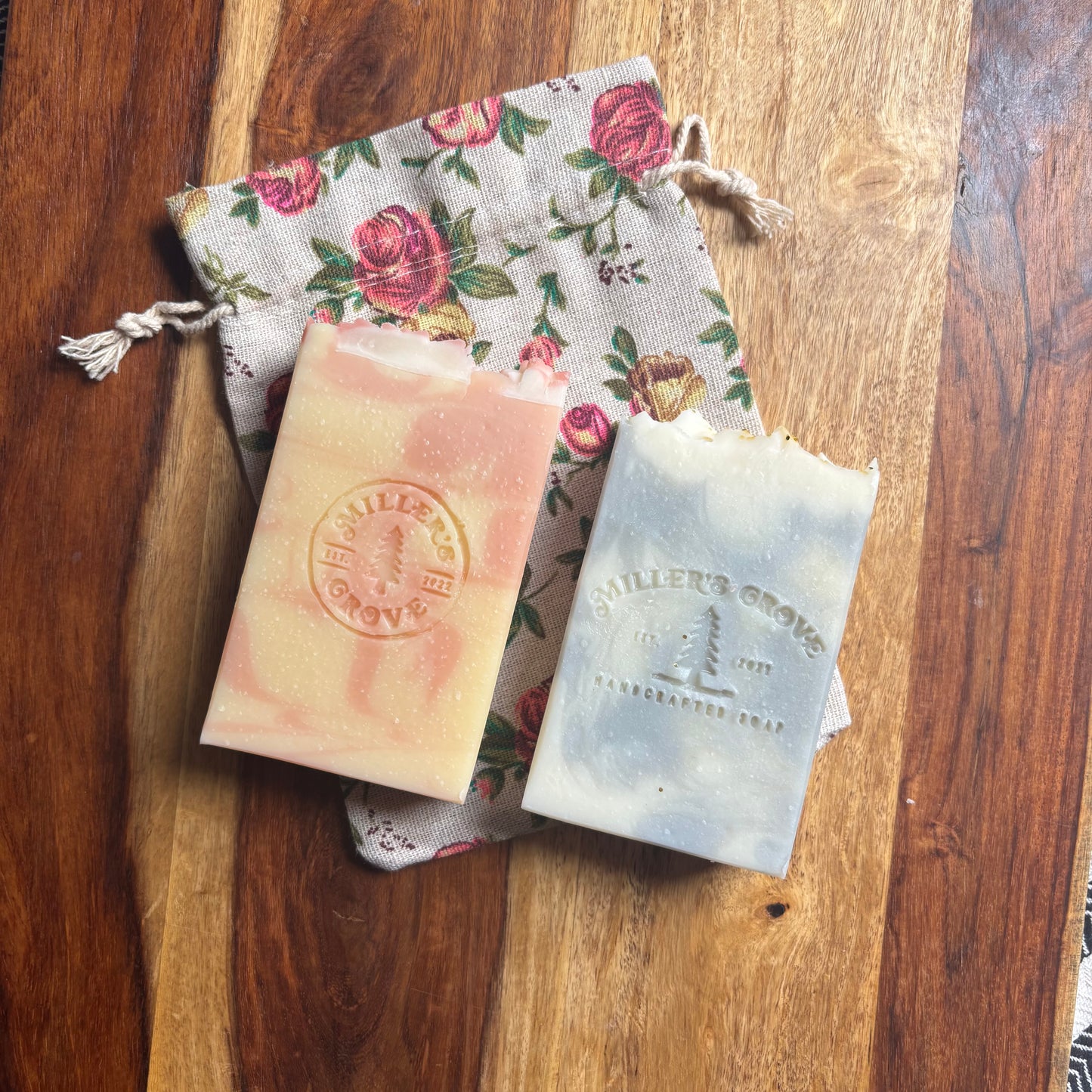 Two bars of soap with 'Miller's Grove' branding on a wooden surface.