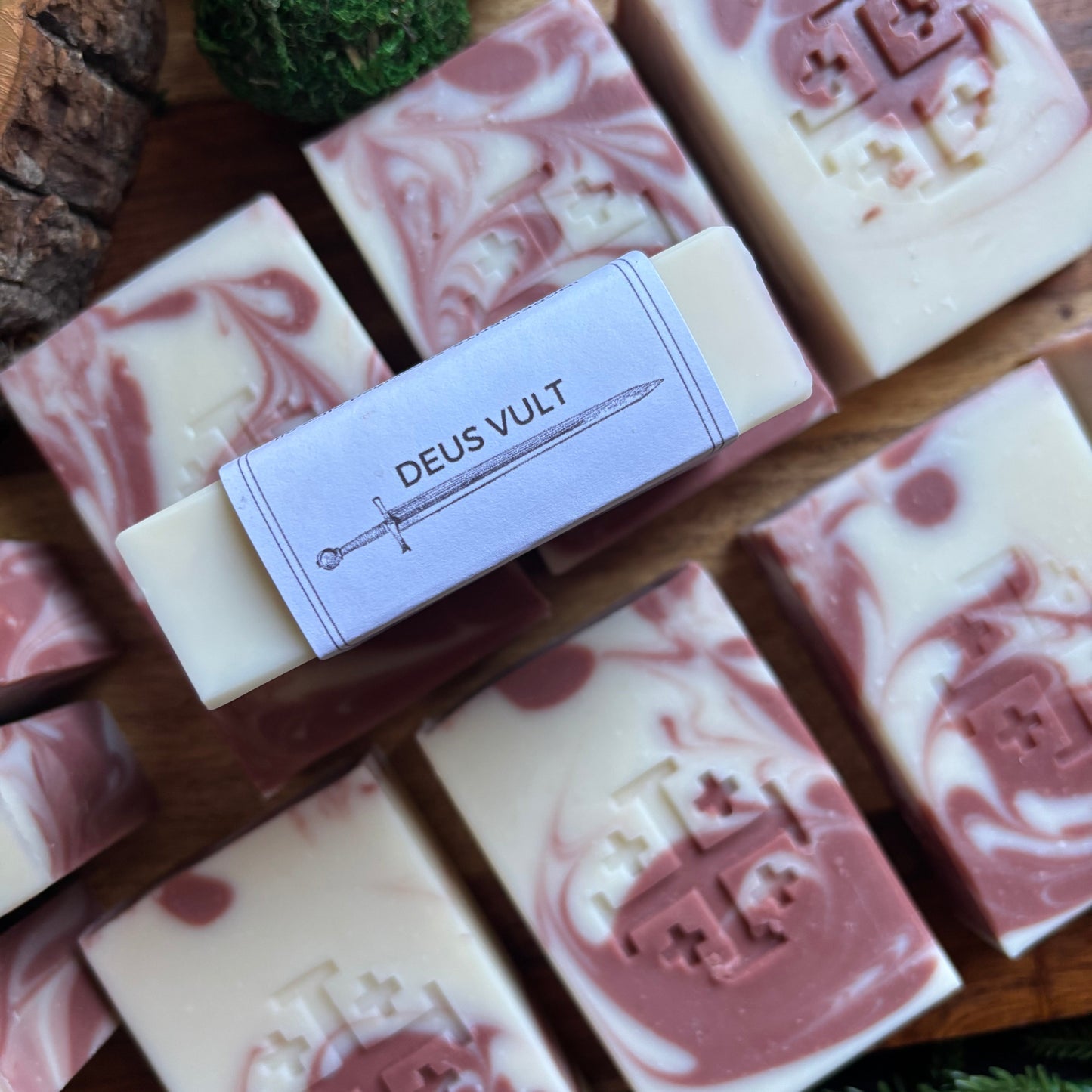 Marbled soap bars with a visible brand label on a wooden surface.