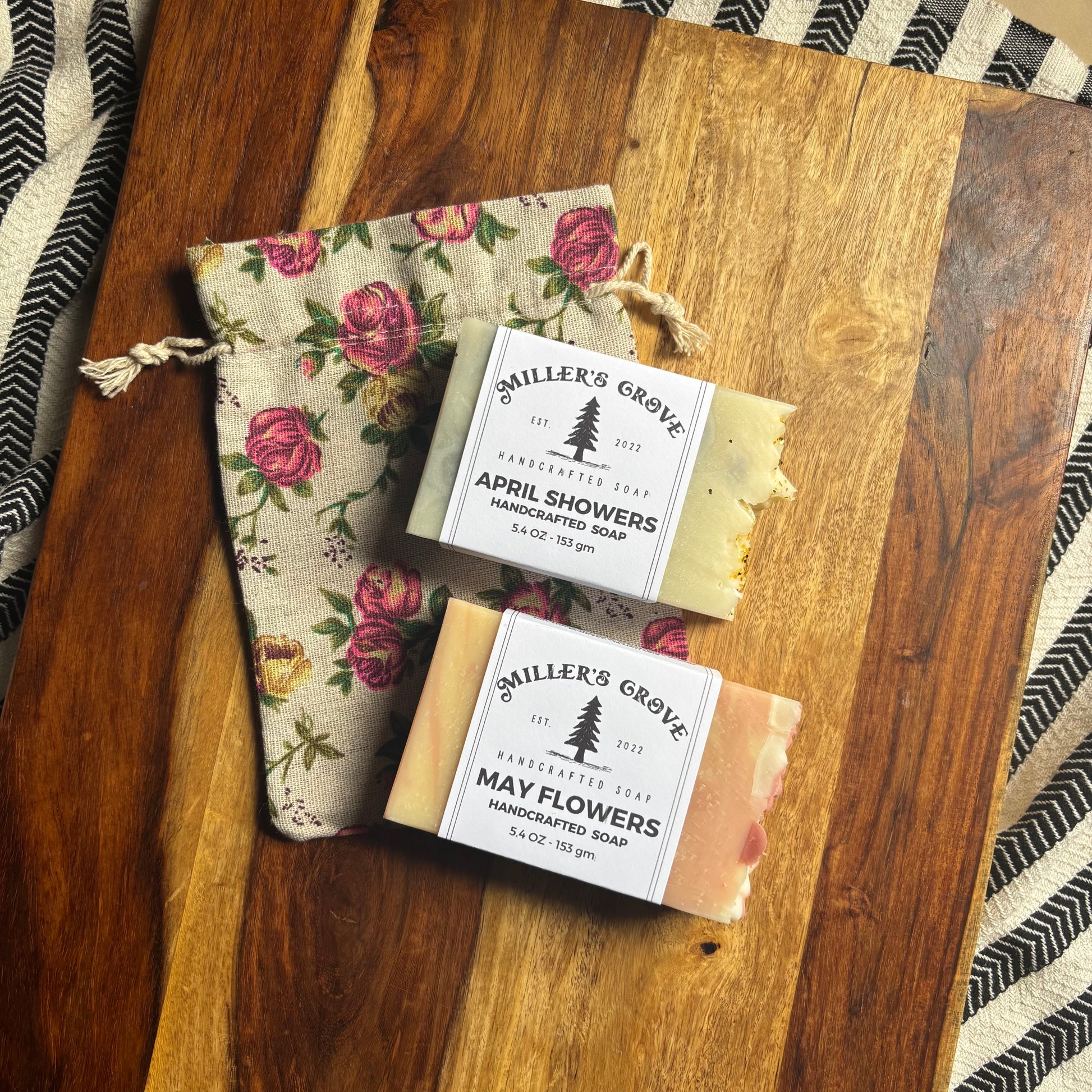 Two bars of soap with 'Miller's Grove' branding on a wooden surface.