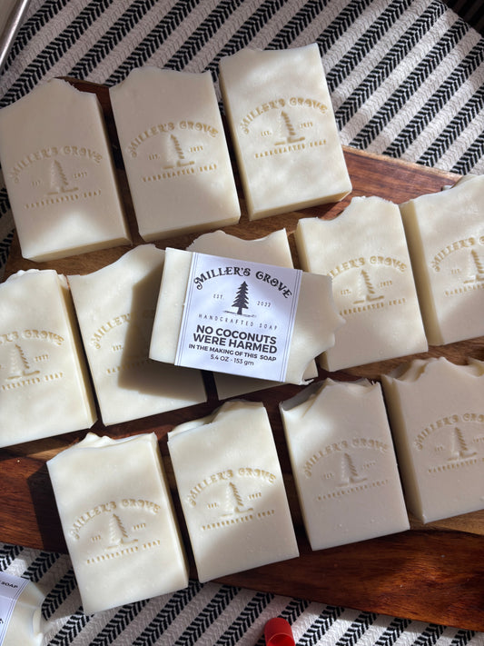White soap bars with a label on a wooden tray