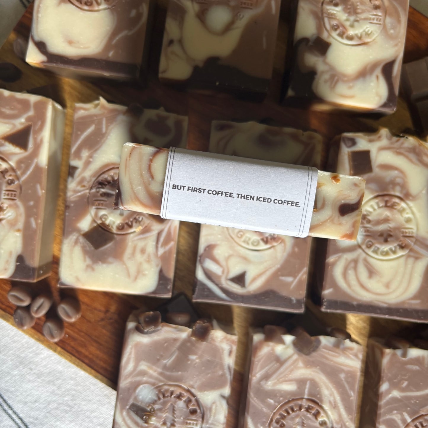 Coffee-themed soap bars with a label on a wooden surface