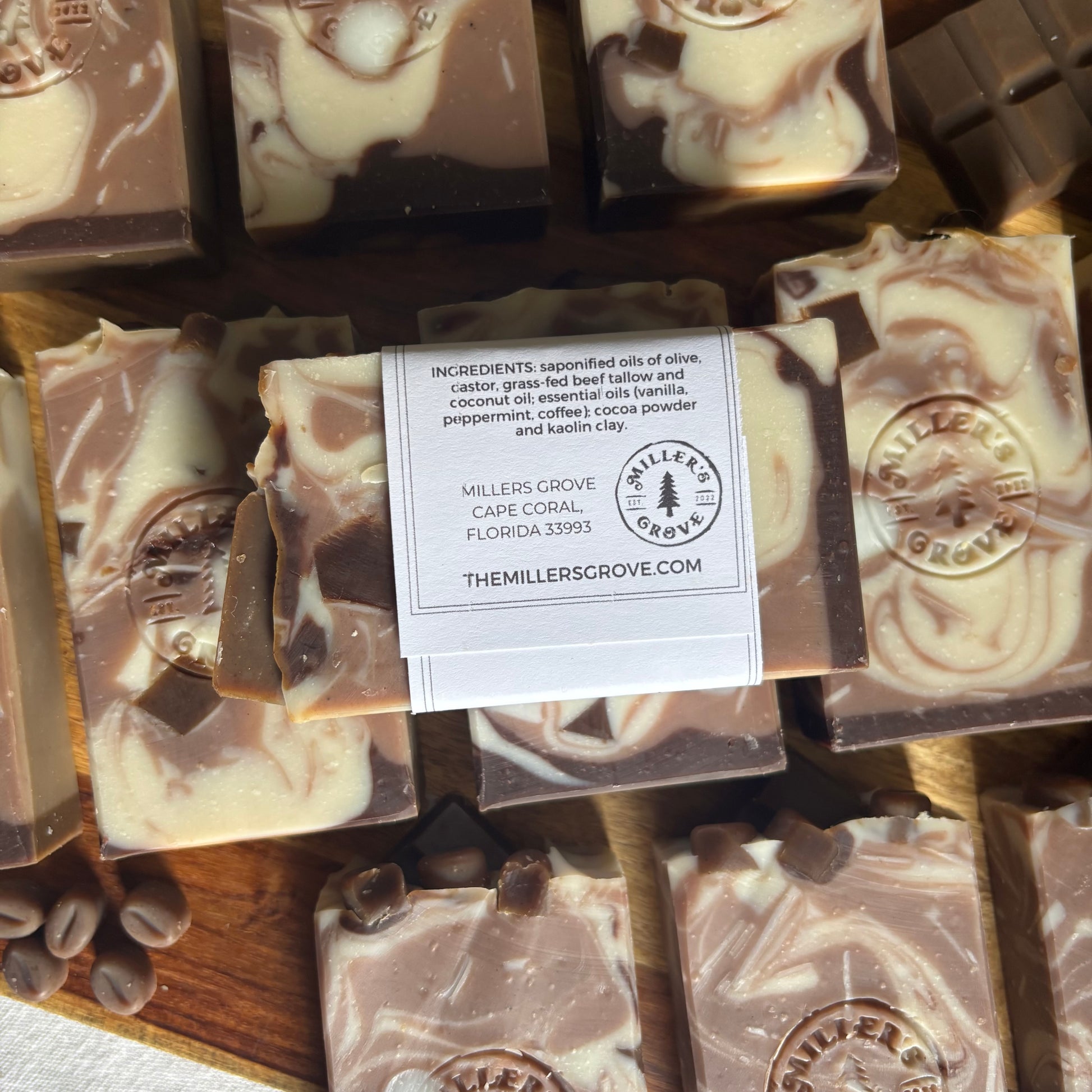 Marbled chocolate soap bars with a label on a wooden surface