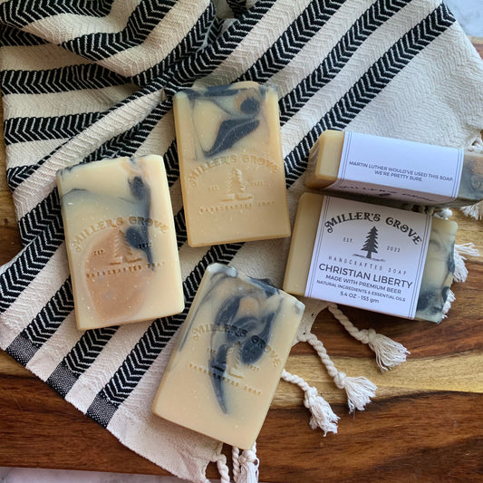 beige soap bars with tan and black swirls.  Soap label shows the name of the soap is "Christian Liberty"