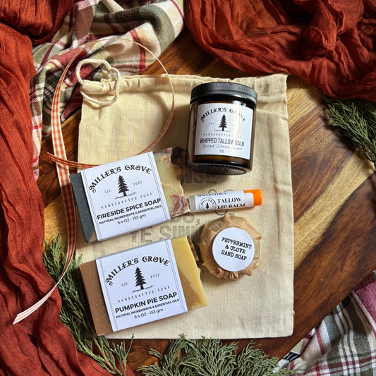 Collection of Miller's Grove soap and candle products on a wooden surface with fall-themed decor.