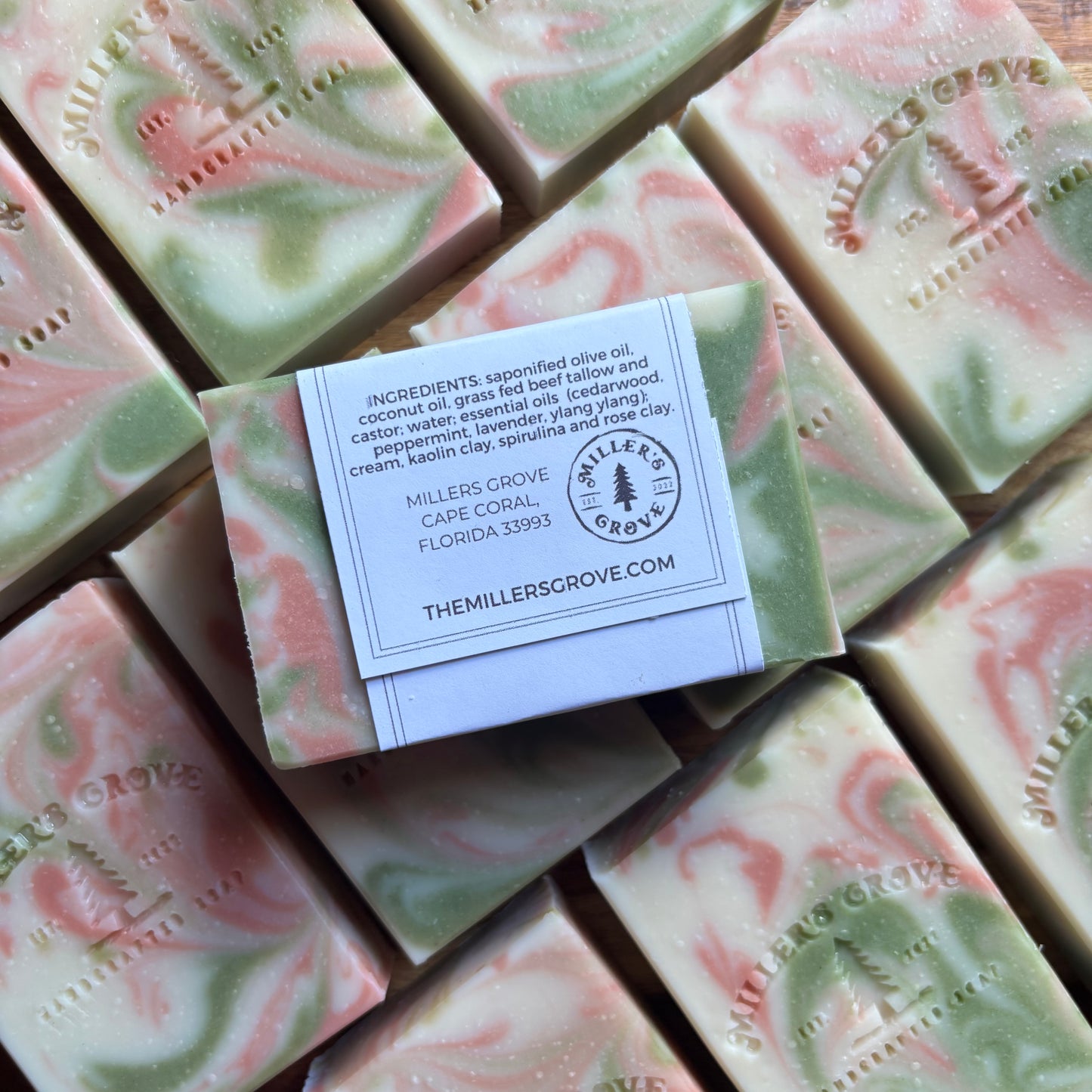 Green and pink swirled soap bars with a label on top, featuring 'The Miller's Grove' branding.