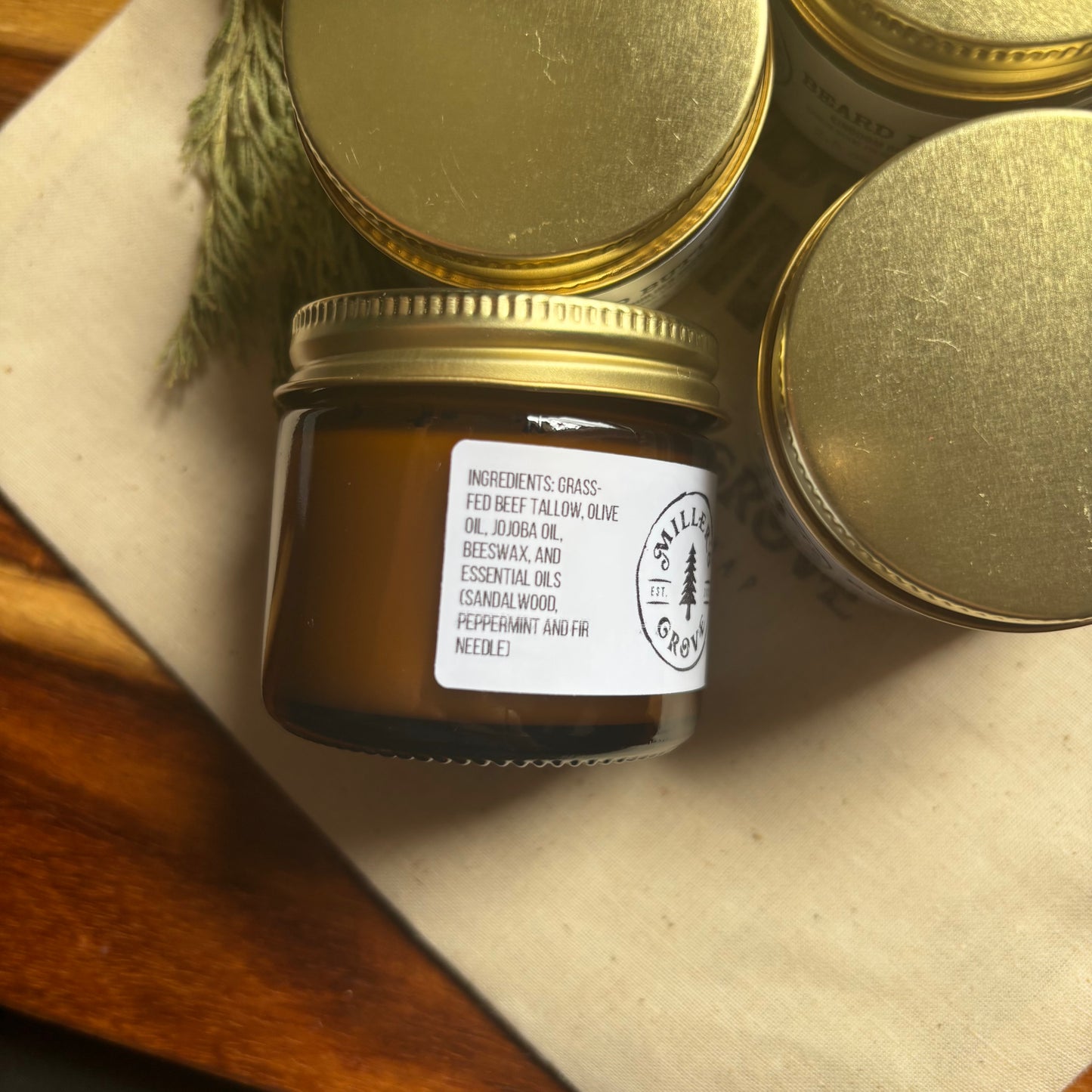 Jar of candle with gold lid on a textured surface