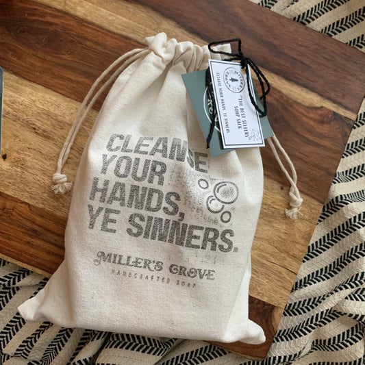 Cotton drawstring bag with "cleanse your hands ye sinners" stamped on the front