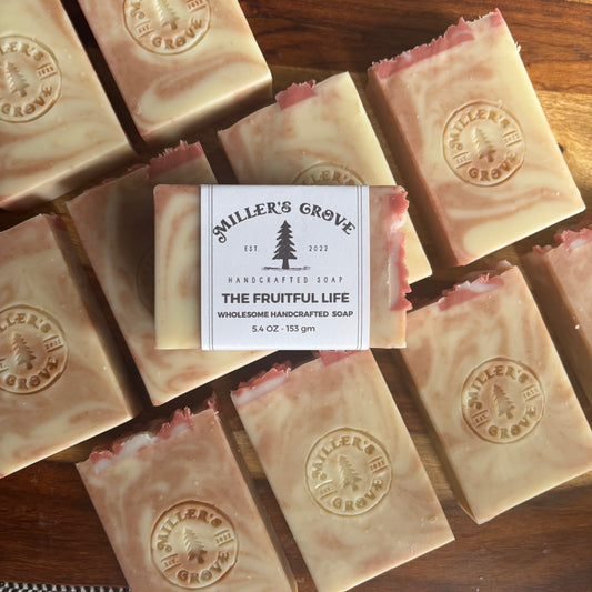 Handcrafted soap bars with 'Miller's Grove' branding on a wooden surface.