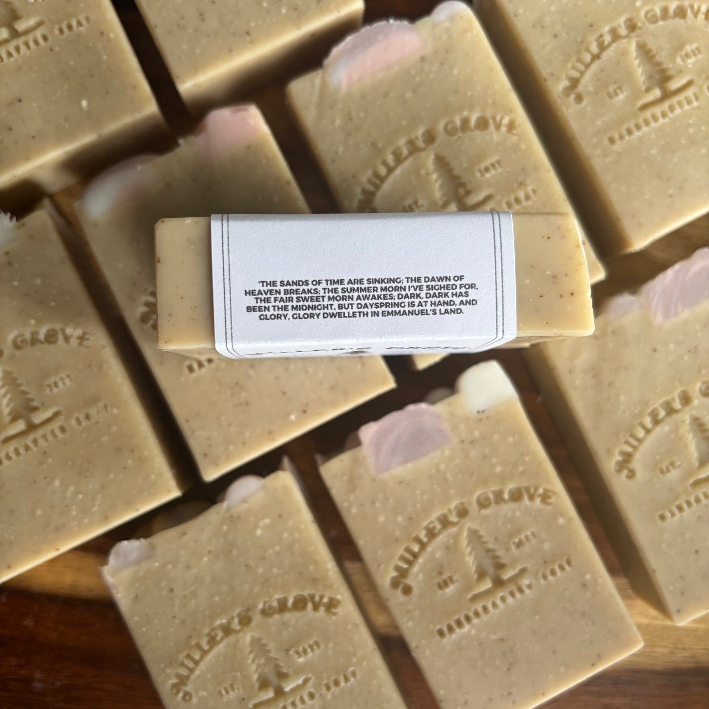 Bar of soap with a label on top of other soap bars