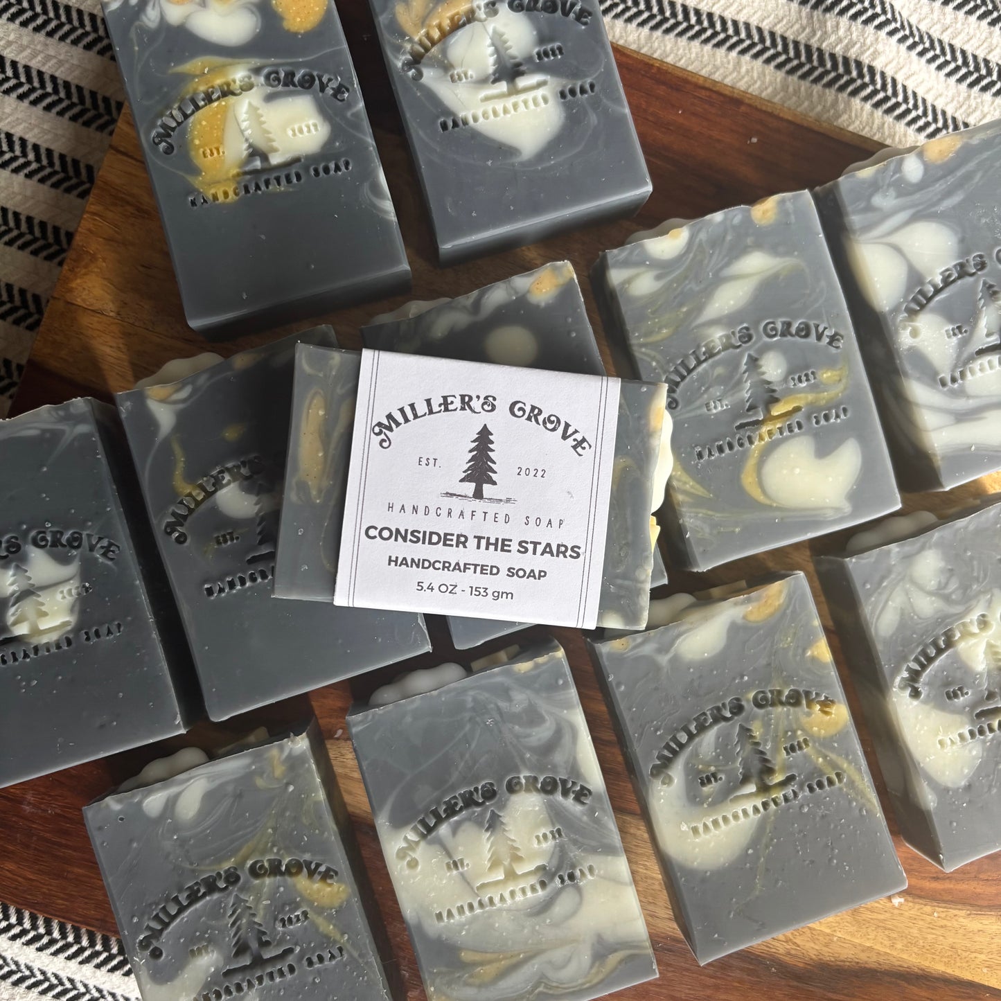 Miller's Grove soap bars with a label on a wooden surface