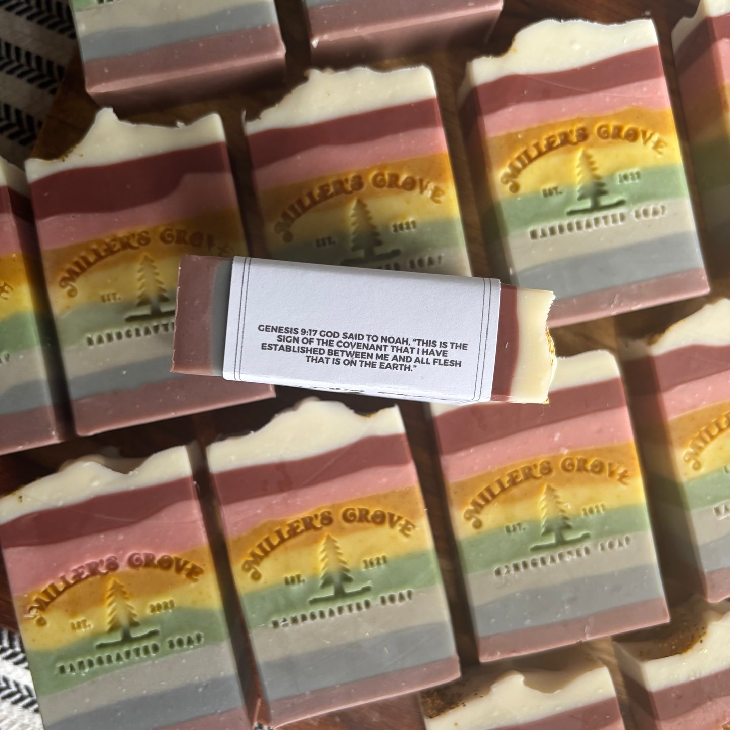 Colorful soap bars with 'Miller's Grove' branding on a metal surface.