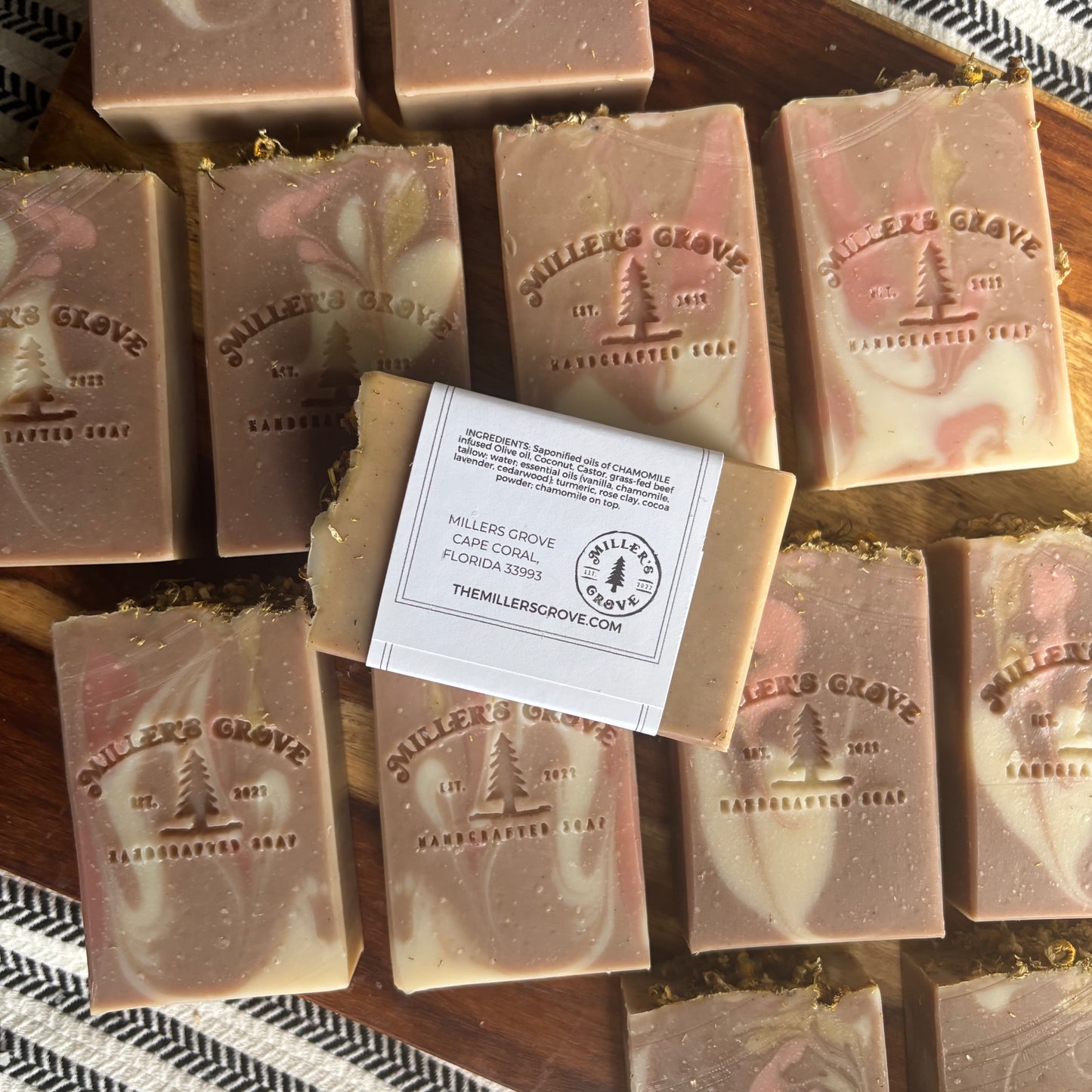 Milled Grove soap bars on a wooden surface with a label.