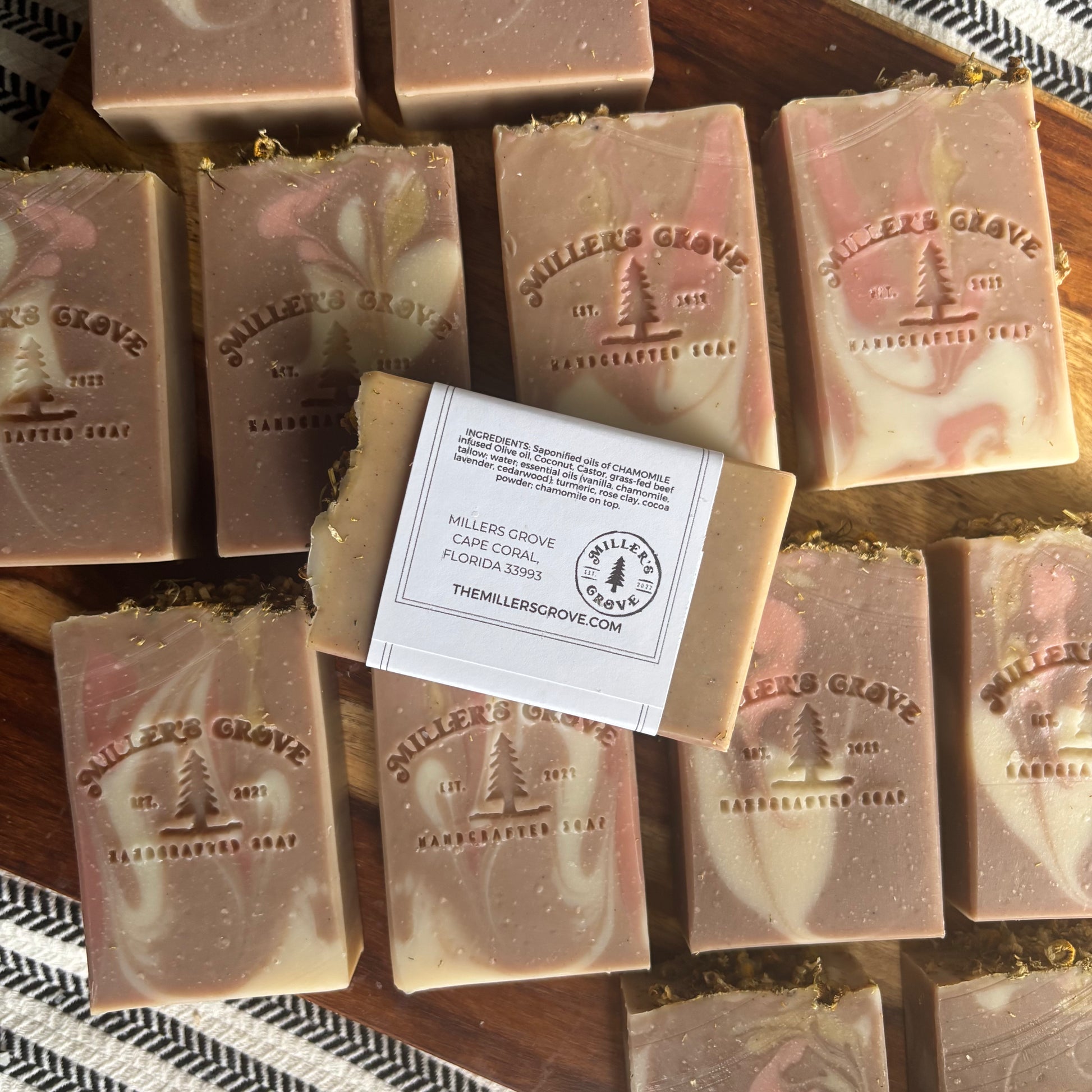 Milled Grove soap bars on a wooden surface with a label.
