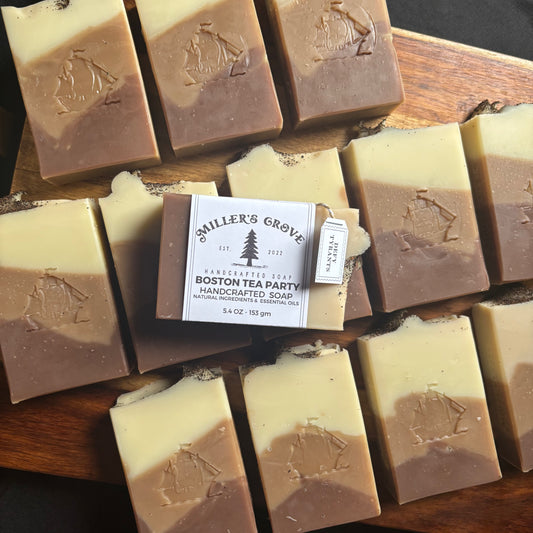 Handcrafted soap bars with a visible brand label on a wooden surface