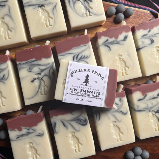 Handcrafted soap bars with a 'Miller's Grove' label on a wooden surface.