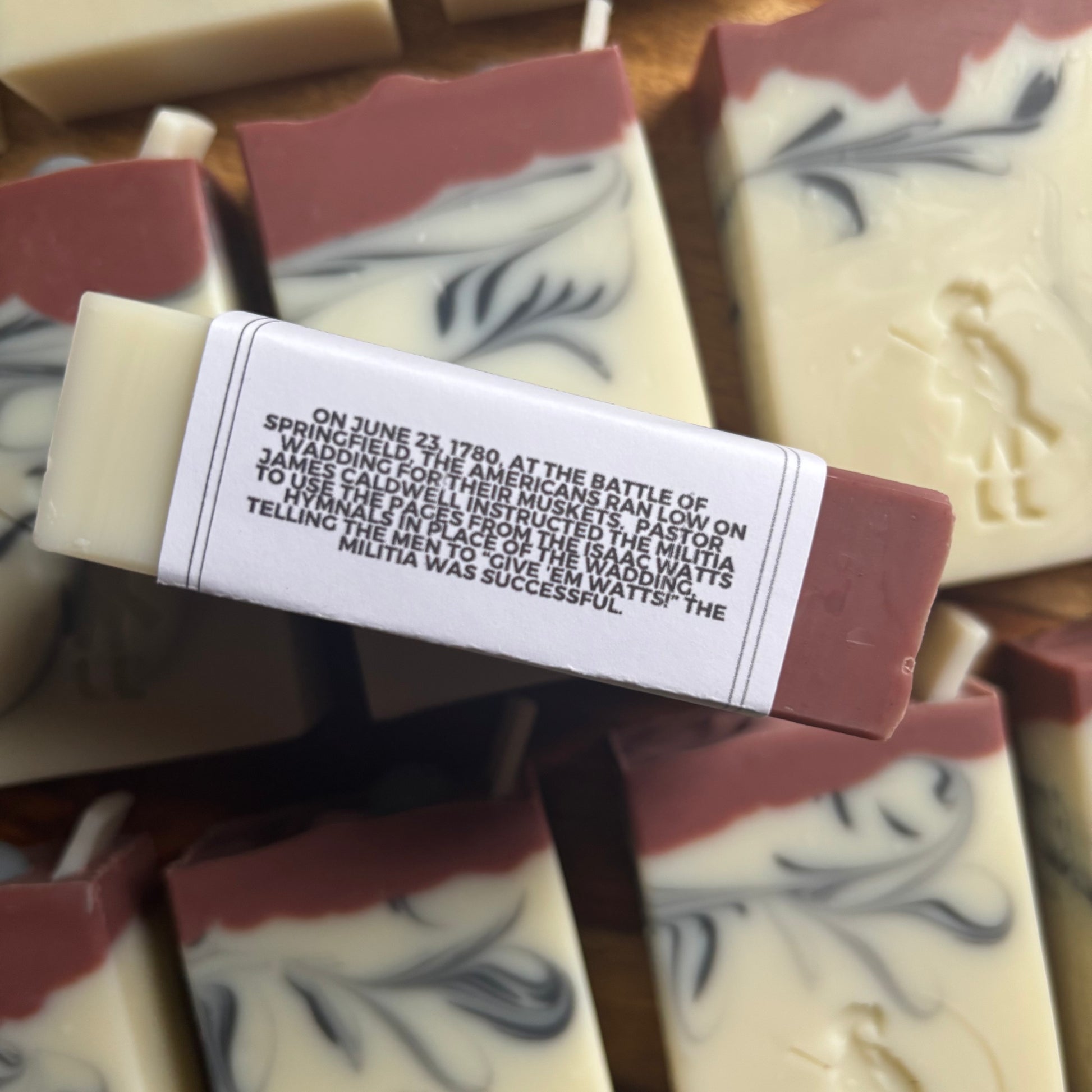 Bar of soap with a historical text label on a wooden surface