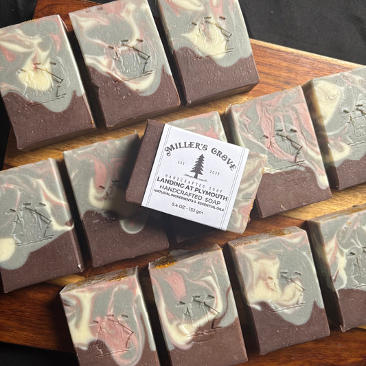 Handcrafted soap bars with a 'Miller's Grove' label on a wooden surface