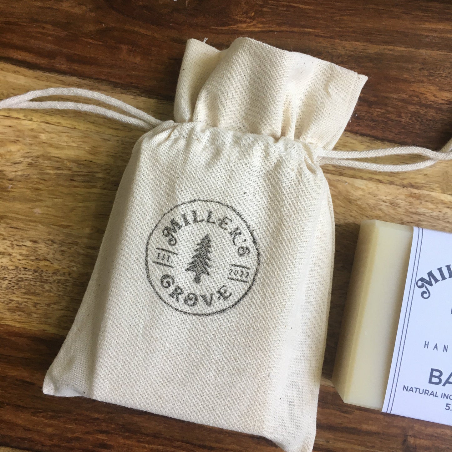 Cotton drawstring bag holding a bar of soap