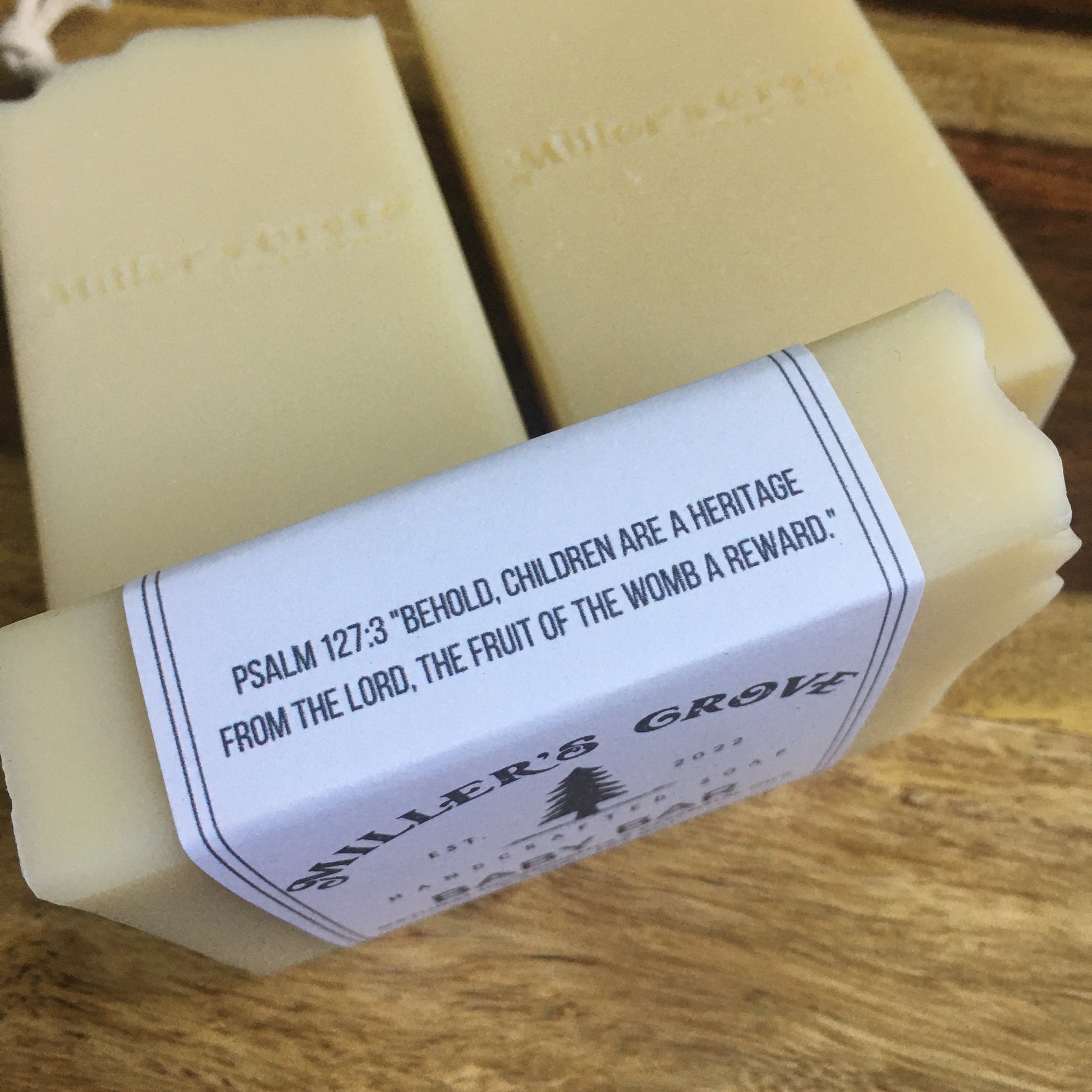 White bar of soap with Psalm 127:3 verse on the side label